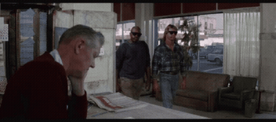 Man In Red Sweater Sitting At Table With Two Men GIF
