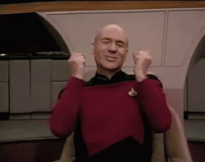 Man In Red Sweater Sitting With Arms Up Saying Thank You GIF