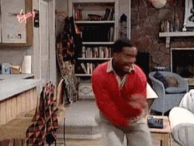 Man In Red Sweater Standing In Living Room GIF