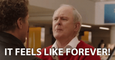 Man In Red Sweater Talking To Man In Black Jacket GIF