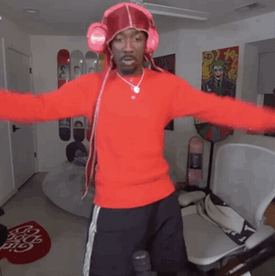 Man In Red Sweater With Headphones Standing In Room GIF