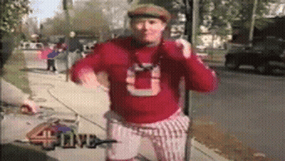 Man in Red Sweater With Letter U on Sidewalk