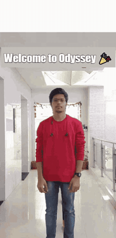 Man In Red Sweater With Welcome To Odyssey Sign GIF