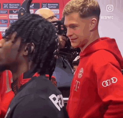 Man In Red T-Mobile Hoodie Next To Man In Black Shirt GIF