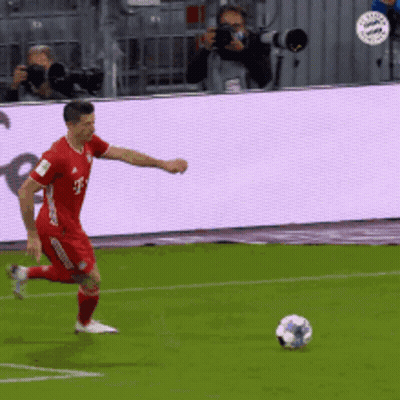 Man In Red T-Mobile Jersey Kicks Soccer Ball GIF