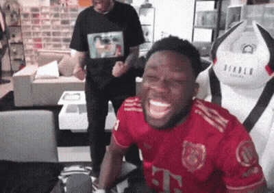 Man In Red T-Mobile Jersey Laughing In Living Room GIF