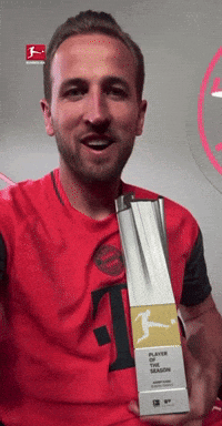 Man In Red T-Shirt Holding Player Of The Season Trophy GIF