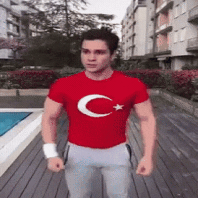 Man in Red T-Shirt With Crescent Moon and Star