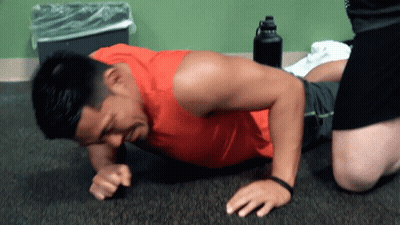 Man In Red Tank Top Doing Push Ups GIF