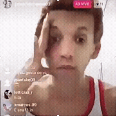 Man In Red Tank Top Holding Hand To Forehead GIF
