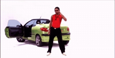 Man In Red Tank Top In Front Of Green Car GIF