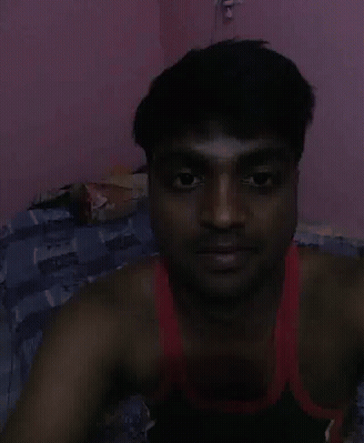 Man In Red Tank Top Lying On Bed GIF