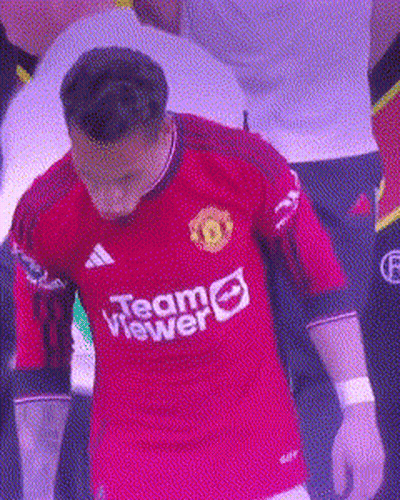 Man In Red Team Viewer Jersey Standing In Crowd GIF