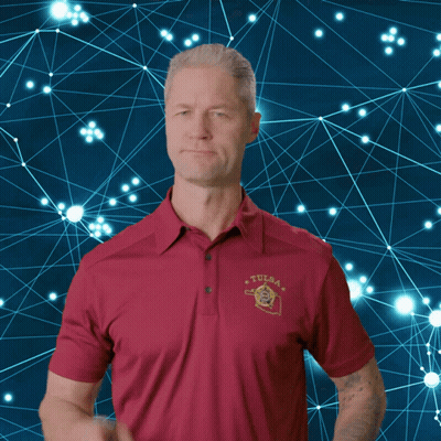 Man in Red Tulsa Polo Shirt Pointing Finger