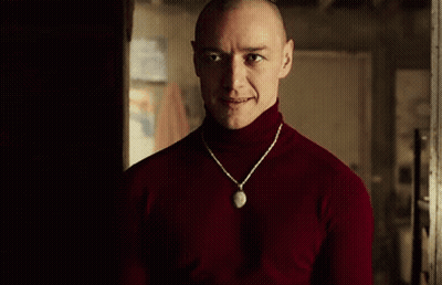 Man In Red Turtleneck And Necklace In Dark Room GIF