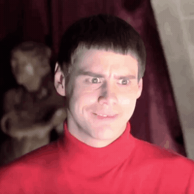 Man In Red Turtleneck Making Funny Face At Statue GIF