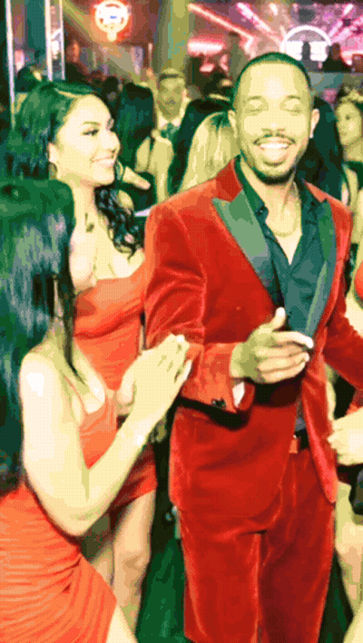 Man In Red Tuxedo Dancing With Two Women In Red Dresses GIF