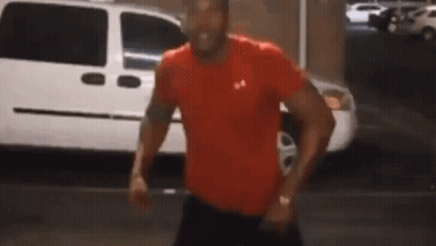 Man In Red Under Armour Shirt Standing In Front Of White Van GIF