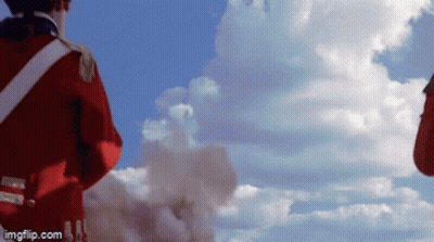 Man In Red Uniform Against Cloudy Blue Sky GIF