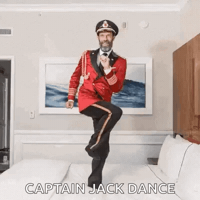 Man In Red Uniform Dancing On Bed GIF