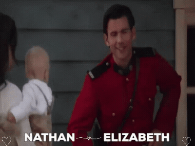 Man In Red Uniform Holding Baby GIF