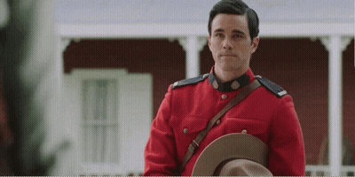 Man In Red Uniform Holding Hat GIF