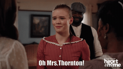 Man In Red Uniform In Front Of Heart & Name Building GIF