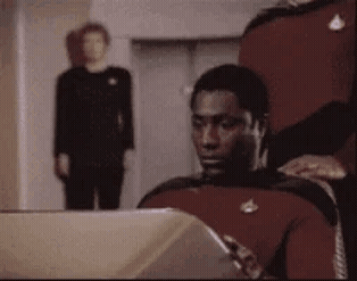 Man In Red Uniform Sitting At Computer GIF