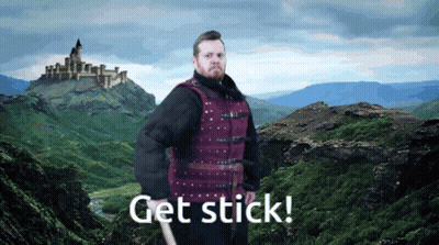 Man In Red Vest By Mountain Saying Get Stick GIF