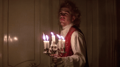 Man In Red Vest Holding Hand To Nose GIF