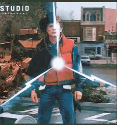 Man In Red Vest In Front Of Studio Universal Building GIF