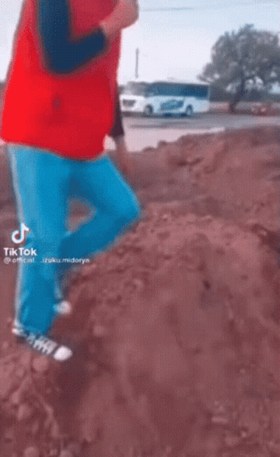 Man In Red Vest Jumping With Hammer GIF