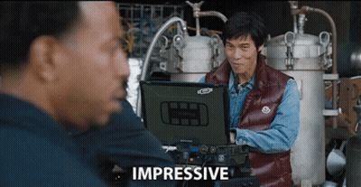 Man In Red Vest Looking At Impressive Laptop GIF