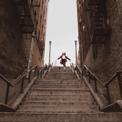 Man In Red White And Blue Outfit Walking Up Stairs GIF