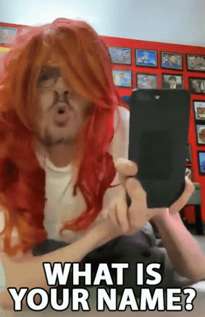 Man In Red Wig Holding Cell Phone Asking What Is Your Name GIF