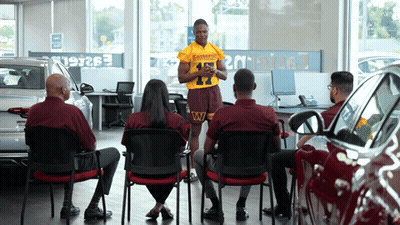 Man In Redskins Jersey Giving Presentation GIF