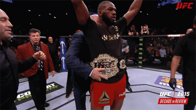 Man In Reebok Shorts Holding UFC Belt GIF