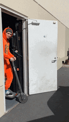 Man In Reeses Suit Driving Scooter GIF