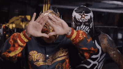 Man In Rey Fenix Hoodie Next To Masked Man GIF