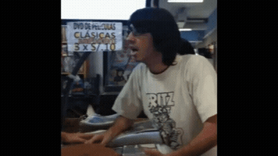 Man In Ritz Shirt In Front Of 3 X 5 / 10 Sign GIF