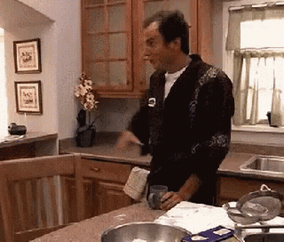 Man In Robe Holding Mug In Kitchen GIF