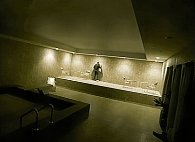 Man In Robe Standing In Bathtub GIF