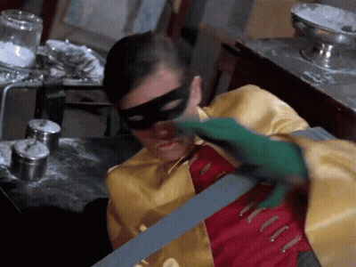 Man In Robin Costume Holding Bat GIF