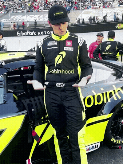 Man In Robin Hood Shirt Beside Race Car GIF