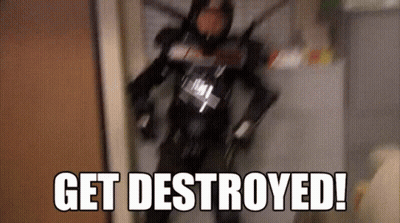 Man In Robot Costume Walking Down Hallway Saying Get Destroyed GIF