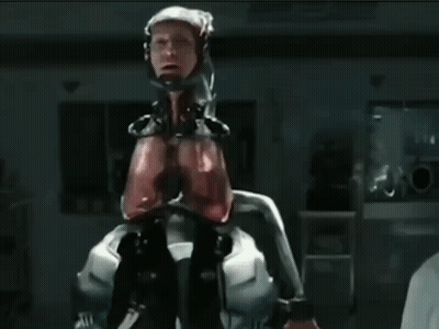 Man In Robotic Suit Near Emergency Exit Sign GIF