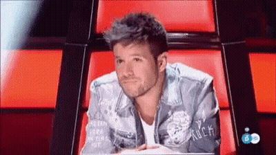 Man In Rock-Embroidered Denim Jacket Red Chair GIF