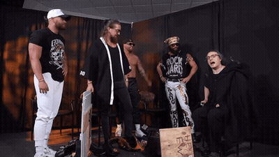 Man In Rock Yard Shirt With Other Men GIF