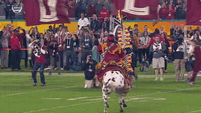 Man In Roman Helmet Holding Sword In Front Of Suited Man GIF