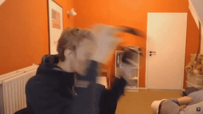 Man In Room With Orange Wall And White Door GIF